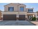 Charming two-story home featuring a three-car garage, neutral stucco, and inviting front entrance at 23407 W Ashleigh Marie Dr, Buckeye, AZ 85326