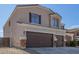 Charming two-story home featuring a three-car garage, neutral stucco, and inviting front entrance at 23407 W Ashleigh Marie Dr, Buckeye, AZ 85326