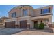 Charming two-story home featuring a three-car garage, neutral stucco, and inviting front entrance at 23407 W Ashleigh Marie Dr, Buckeye, AZ 85326