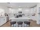 Modern kitchen featuring white cabinetry, stainless steel appliances, and a large center island with seating at 23407 W Ashleigh Marie Dr, Buckeye, AZ 85326