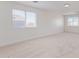 A spacious living room with two windows letting in ample natural light at 23407 W Ashleigh Marie Dr, Buckeye, AZ 85326