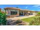 A view of the backyard, a stainless steel grill, and the covered patio with furniture and desert landscaping at 24413 S Lakeway Sw Cir, Sun Lakes, AZ 85248