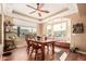 Cozy dining room with large windows, a wooden table, and plenty of natural light, perfect for Gathering meals at 24413 S Lakeway Sw Cir, Sun Lakes, AZ 85248