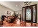 Elegant foyer with hardwood floors, decorative chandelier, and a view into the living spaces at 24413 S Lakeway Sw Cir, Sun Lakes, AZ 85248