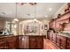 Open kitchen featuring stainless steel appliances, granite countertops, and a breakfast bar overlooking the dining area at 24413 S Lakeway Sw Cir, Sun Lakes, AZ 85248