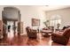 Spacious living room featuring hardwood floors, neutral paint, and large windows at 24413 S Lakeway Sw Cir, Sun Lakes, AZ 85248