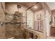 Bathroom shower features beautiful tile work, rainfall shower head, and a built-in niche for storage at 24413 S Lakeway Sw Cir, Sun Lakes, AZ 85248