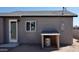 Exterior shot of the home showcasing the water heater under a roof, an outdoor light, and window at 246 E Central Ave, Coolidge, AZ 85128