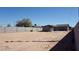 Wide shot of the backyard, showcasing the expansive dirt lot and block wall at 246 E Central Ave, Coolidge, AZ 85128