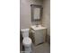 Bathroom with a pedestal sink, gray vanity, and modern toilet at 246 E Central Ave, Coolidge, AZ 85128