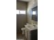 Bright bathroom featuring neutral walls, tiled floor, a vanity with a sink, and a window at 246 E Central Ave, Coolidge, AZ 85128