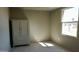 Bright bedroom featuring neutral walls, tiled floor, a built-in wardrobe and a light-filled window at 246 E Central Ave, Coolidge, AZ 85128