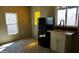 The kitchen featuring herringbone floors, white cabinets and a black fridge at 246 E Central Ave, Coolidge, AZ 85128