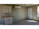 Clean kitchenette design with white cabinets, mounted AC unit, and plenty of space at 246 E Central Ave, Coolidge, AZ 85128