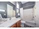 Bathroom featuring a single sink and vanity, a window view, and a tub with shower at 27709 N 129Th Ln, Peoria, AZ 85383