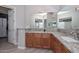 Bathroom featuring double sinks with granite countertops, and light wood cabinets at 27709 N 129Th Ln, Peoria, AZ 85383