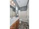 Bathroom featuring a single sink and vanity, a window view, and a tub with shower at 27709 N 129Th Ln, Peoria, AZ 85383