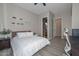 Bedroom featuring a queen bed, decor shelves, and a doorway to the bathroom at 27709 N 129Th Ln, Peoria, AZ 85383