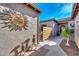 Side courtyard features decorative metal art, a privacy screen, and a charming seating area at 27709 N 129Th Ln, Peoria, AZ 85383