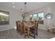 Dining room with wooden table and chairs, chandelier, and bright natural light at 27709 N 129Th Ln, Peoria, AZ 85383