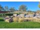 Picturesque entrance to the Trilogy community with stone waterfall feature and mature landscaping at 27709 N 129Th Ln, Peoria, AZ 85383