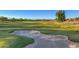 Scenic view of the golf course with sand trap, lush green grass and mountain views at 27709 N 129Th Ln, Peoria, AZ 85383