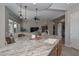 Kitchen island with granite countertops, a sink, and stylish pendant lighting at 27709 N 129Th Ln, Peoria, AZ 85383