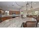 Kitchen featuring a large island with granite countertops, a breakfast bar, and modern appliances at 27709 N 129Th Ln, Peoria, AZ 85383