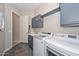 Laundry room featuring new appliances, a sink and vanity, and access to another room at 27709 N 129Th Ln, Peoria, AZ 85383