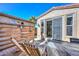 Inviting patio with wood chairs and privacy screen, perfect for outdoor relaxation and entertaining at 27709 N 129Th Ln, Peoria, AZ 85383