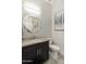 Elegant powder room features a vanity with granite countertop, modern faucet and patterned tile floor at 2777 W Queen Creek Rd # 13, Chandler, AZ 85248