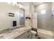 This bathroom features a marble countertop, modern lighting, and neutral-toned tile in the shower and backsplash at 2777 W Queen Creek Rd # 13, Chandler, AZ 85248