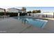 Community pool surrounded by lounge chairs and tables for residents to relax and enjoy at 2777 W Queen Creek Rd # 13, Chandler, AZ 85248