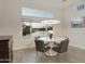 Dining room with large window overlooking water, modern light fixture, and tile flooring at 2777 W Queen Creek Rd # 13, Chandler, AZ 85248