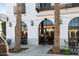 Exterior view of a coffee house with black metal framed arched windows and string lights at 2777 W Queen Creek Rd # 13, Chandler, AZ 85248