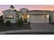 Charming home with a tile roof, three arch window and a manicured landscape, set against a vibrant sunset at 2777 W Queen Creek Rd # 13, Chandler, AZ 85248