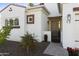 The front entrance of this inviting single-Gathering home with a brick pathway and wrought iron entry gate at 2777 W Queen Creek Rd # 13, Chandler, AZ 85248