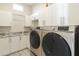 Laundry room with white cabinetry, neutral countertops, updated machines, and patterned flooring at 2777 W Queen Creek Rd # 13, Chandler, AZ 85248