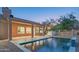 Inviting backyard pool and covered patio with view of dusk sky in desert landscape at 29399 N 67Th Way, Scottsdale, AZ 85266