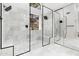 Modern bathroom featuring a glass shower with a rain shower head, a built-in bench, and marble tiling at 29399 N 67Th Way, Scottsdale, AZ 85266