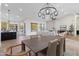 Elegant dining area featuring a modern chandelier and seamless flow into living spaces at 29399 N 67Th Way, Scottsdale, AZ 85266