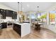 Modern kitchen with a large center island, pendant lighting, stainless steel appliances, and hardwood flooring at 29399 N 67Th Way, Scottsdale, AZ 85266