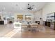 Spacious living room with a fireplace, hardwood floors, and a fan to keep you cool in the summer at 29399 N 67Th Way, Scottsdale, AZ 85266