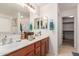 Bathroom with a double vanity, mirrors, and storage cabinets at 29576 N Gecko Trl, San Tan Valley, AZ 85143