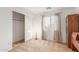 Bedroom featuring neutral tones, a built-in cabinet, and a sliding-door closet at 29576 N Gecko Trl, San Tan Valley, AZ 85143