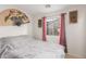 Cozy bedroom featuring a comfortable bed and a window providing natural light at 29576 N Gecko Trl, San Tan Valley, AZ 85143