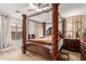 Elegant bedroom featuring a wooden canopy bed, a ceiling fan, and an elegant nightstand at 29576 N Gecko Trl, San Tan Valley, AZ 85143