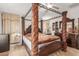 Spacious bedroom featuring a decorative four-poster bed and matching wood furniture at 29576 N Gecko Trl, San Tan Valley, AZ 85143