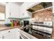 Kitchen featuring stainless steel appliances, glass backsplash, granite countertops and white cabinetry at 29576 N Gecko Trl, San Tan Valley, AZ 85143