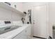 Practical laundry area with modern washer, dryer, and convenient shelving at 29576 N Gecko Trl, San Tan Valley, AZ 85143